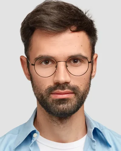 brunet-man-wearing-round-eyeglasses-blue-shirt-scaled-e1748794775145.webp